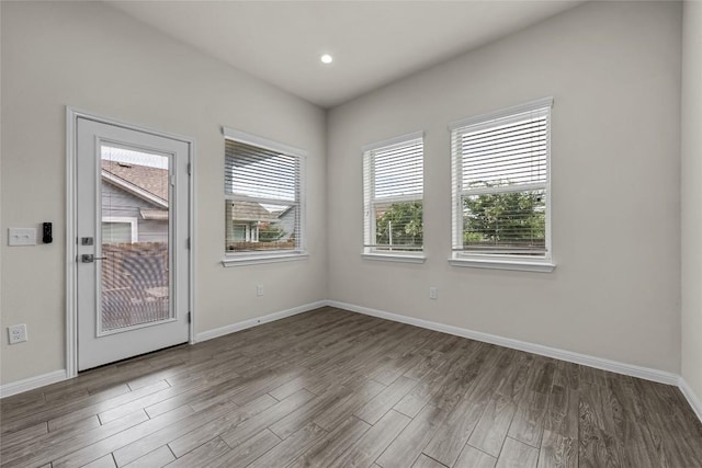 7808 Glover Dr, Austin, TX 78744 - empty room with wood finished floors and recessed lighting