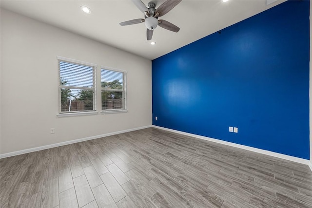7808 Glover Dr, Austin, TX 78744 - unfurnished room with wood finished floors, ceiling fan, and recessed lighting