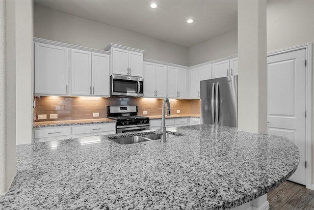 7808 Glover Dr, Austin, TX 78744 - kitchen with stainless steel appliances, white cabinets, recessed lighting, and decorative backsplash