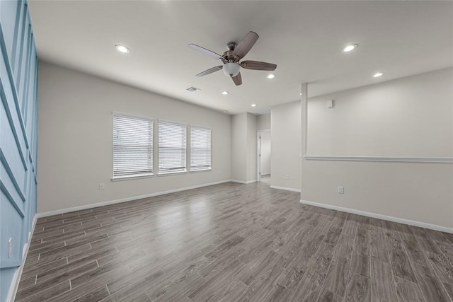 7808 Glover Dr, Austin, TX 78744 - spare room featuring wood finished floors, ceiling fan, and recessed lighting