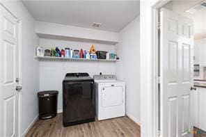 5516 Birmingham Dr, Killeen, TX 76542 - laundry room with washing machine and clothes dryer and wood finished floors