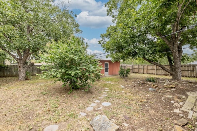 705 Dunning St, Gonzales, TX 78629 - fenced backyard featuring an outdoor structure