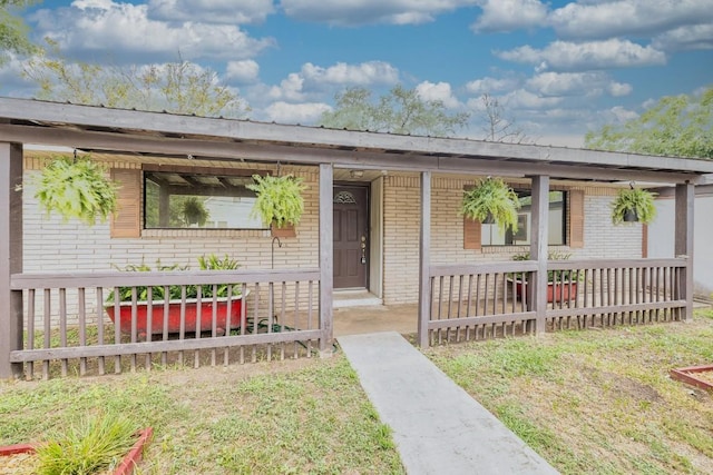 705 Dunning St, Gonzales, TX 78629 - view of front of house with a porch and brick siding
