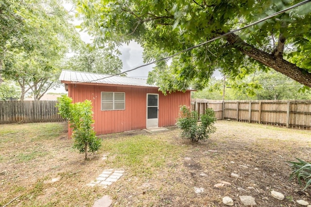 705 Dunning St, Gonzales, TX 78629 - fenced backyard featuring an outdoor structure