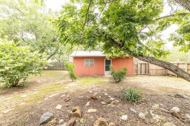 705 Dunning St, Gonzales, TX 78629 - fenced backyard with an outdoor structure