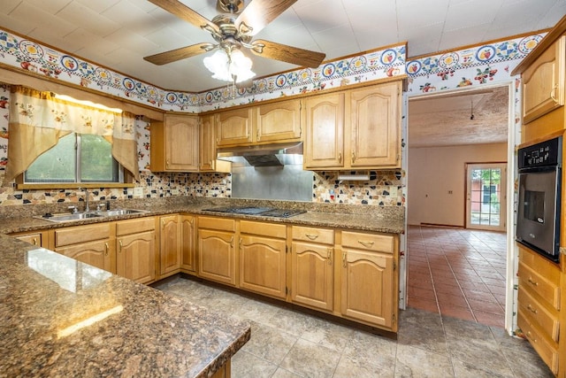 705 Dunning St, Gonzales, TX 78629 - kitchen featuring black electric cooktop, stainless steel oven, under cabinet range hood, ceiling fan, and tasteful backsplash