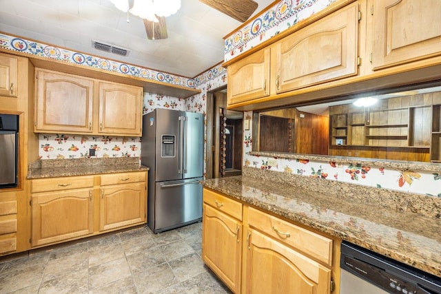 705 Dunning St, Gonzales, TX 78629 - kitchen featuring stainless steel appliances, wallpapered walls, dark stone countertops, ceiling fan, and light stone finish floors