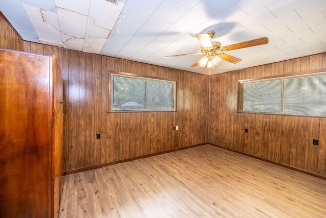705 Dunning St, Gonzales, TX 78629 - spare room with light wood finished floors, wooden walls, and ceiling fan