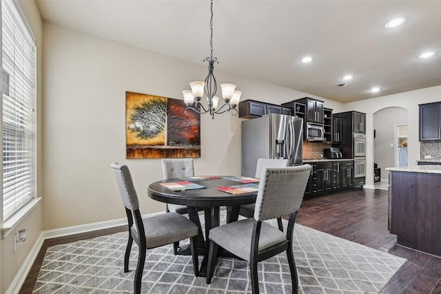 3713 Glastonbury Trl, Pflugerville, TX 78660 - dining space featuring a chandelier, plenty of natural light, arched walkways, dark wood finished floors, and recessed lighting