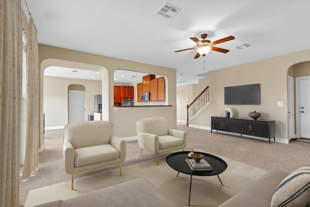 301 Wye Oak St, Austin, TX 78748 - living room with arched walkways, a ceiling fan, light carpet, stairs, and recessed lighting