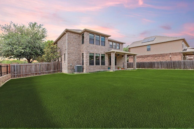 301 Wye Oak St, Austin, TX 78748 - back of property at dusk featuring a fenced backyard and brick siding