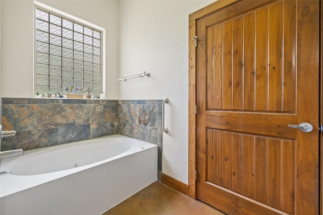 267 Corral Rd, Smithville, TX 78957 - bathroom featuring a bath and baseboards