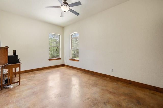 267 Corral Rd, Smithville, TX 78957 - unfurnished room with concrete floors, ceiling fan, and an office area
