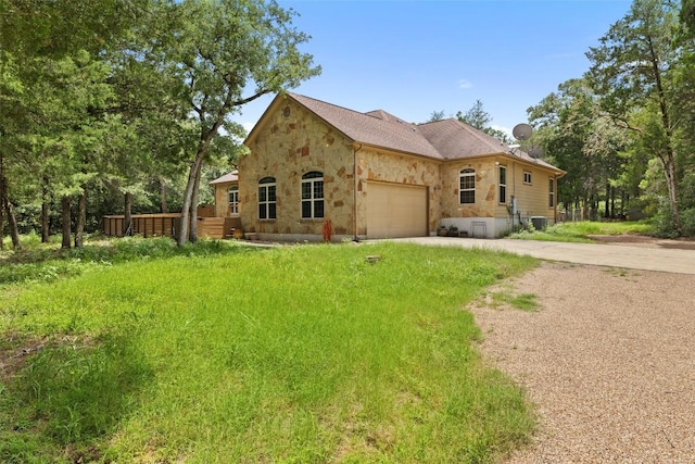 267 Corral Rd, Smithville, TX 78957 - view of front facade featuring stone siding, concrete driveway, and an attached garage