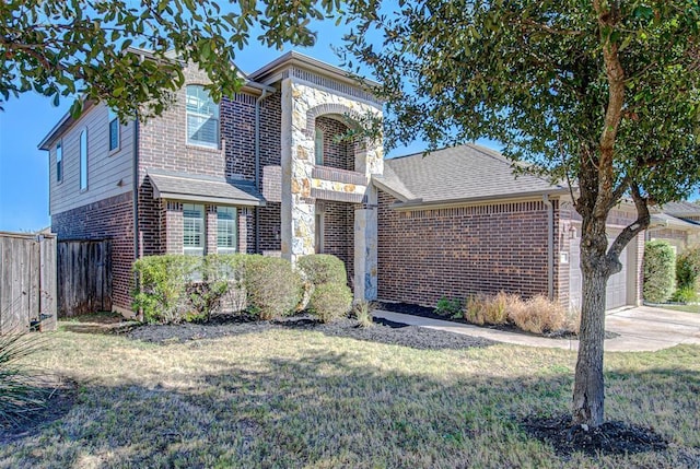 2836 Garnet Ridge Dr, Leander, TX 78641 - traditional-style home featuring brick siding, an attached garage, concrete driveway, stone siding, and a shingled roof
