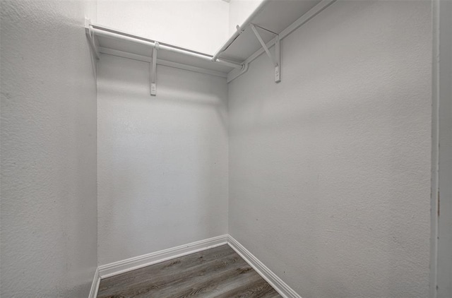 2836 Garnet Ridge Dr, Leander, TX 78641 - walk in closet featuring dark wood-type flooring