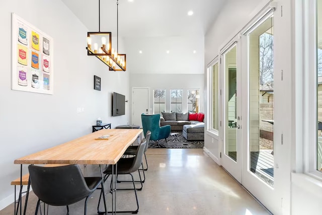 4314 Jinx Ave Unit A, Austin, TX 78745 - dining space featuring concrete flooring, french doors, a chandelier, recessed lighting, and a towering ceiling