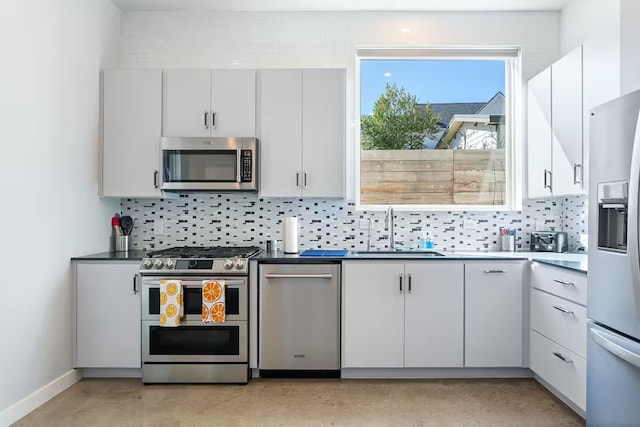 4314 Jinx Ave Unit A, Austin, TX 78745 - kitchen with appliances with stainless steel finishes, decorative backsplash, and white cabinetry