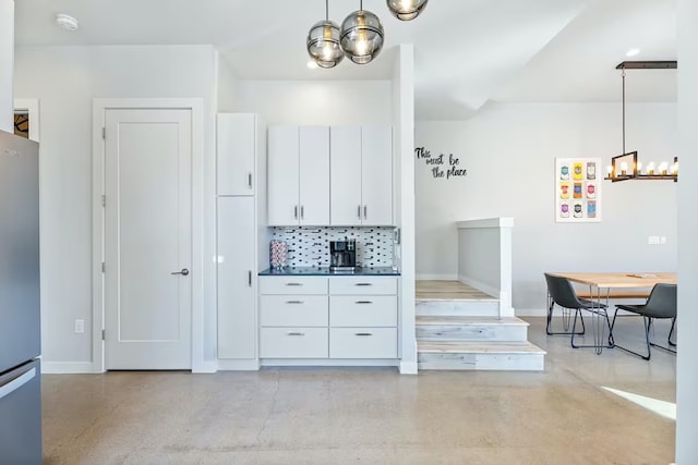 4314 Jinx Ave Unit A, Austin, TX 78745 - kitchen featuring a chandelier, freestanding refrigerator, finished concrete flooring, and white cabinetry