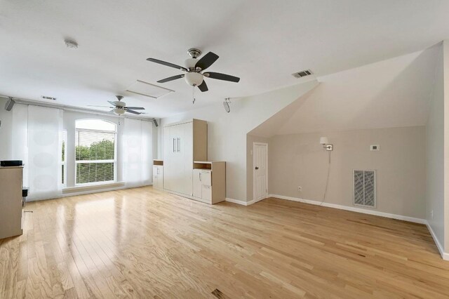 19709 Vilamoura St, Pflugerville, TX 78660 - unfurnished living room with a ceiling fan, light wood-style flooring, and attic access