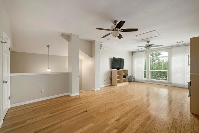 19709 Vilamoura St, Pflugerville, TX 78660 - unfurnished living room with a ceiling fan, light wood-style flooring, and attic access