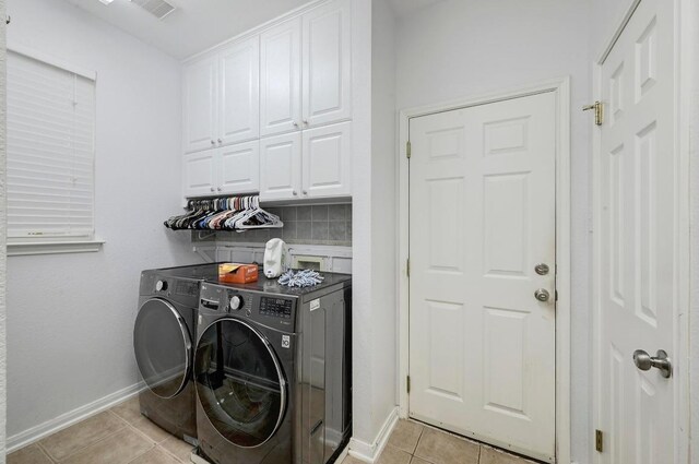 19709 Vilamoura St, Pflugerville, TX 78660 - washroom with cabinet space, light tile patterned floors, and washing machine and clothes dryer