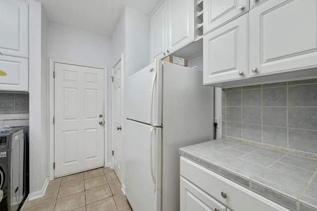 19709 Vilamoura St, Pflugerville, TX 78660 - laundry area with light tile patterned floors and washer / dryer