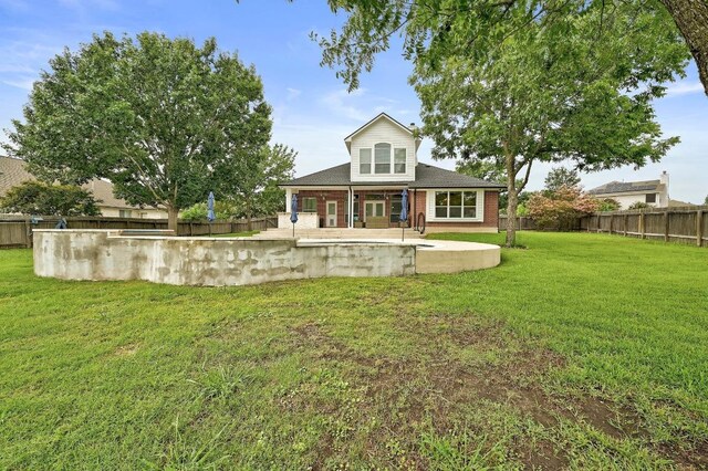 19709 Vilamoura St, Pflugerville, TX 78660 - back of property featuring a patio, a fenced backyard, and brick siding