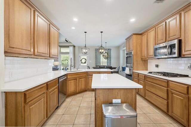 19709 Vilamoura St, Pflugerville, TX 78660 - kitchen featuring stainless steel appliances, a peninsula, light tile patterned flooring, tasteful backsplash, and recessed lighting