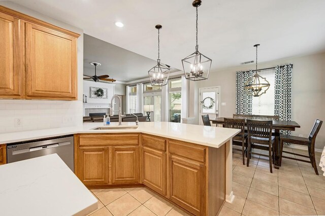 19709 Vilamoura St, Pflugerville, TX 78660 - kitchen featuring dishwasher, a chandelier, light tile patterned flooring, a peninsula, and recessed lighting