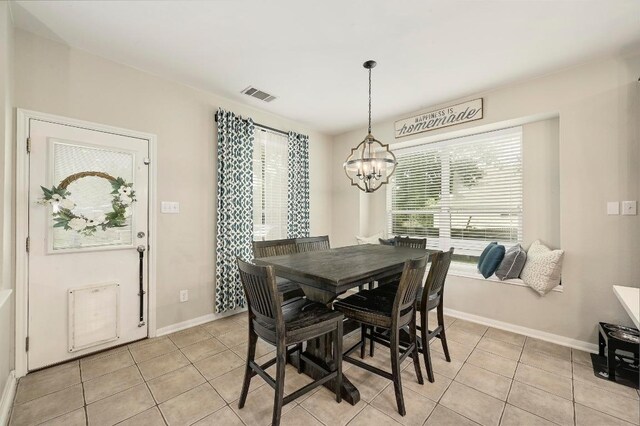 19709 Vilamoura St, Pflugerville, TX 78660 - dining space with a chandelier and light tile patterned floors