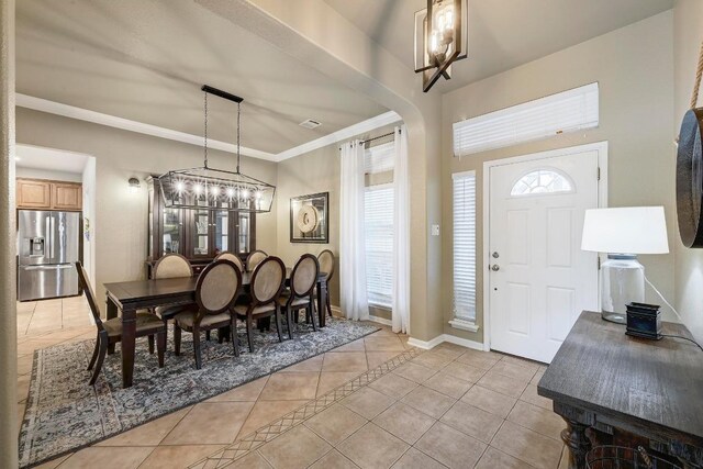 19709 Vilamoura St, Pflugerville, TX 78660 - entrance foyer with light tile patterned floors, a chandelier, and crown molding