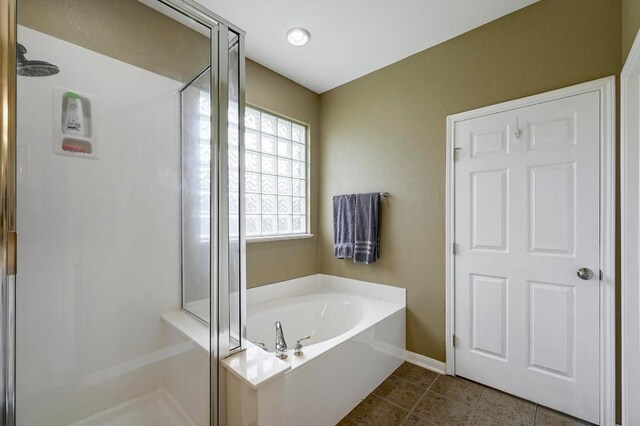 19709 Vilamoura St, Pflugerville, TX 78660 - full bath featuring a stall shower, a garden tub, and tile patterned floors