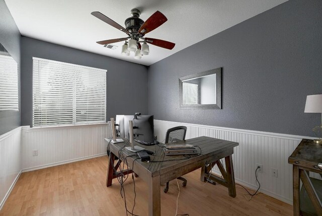 19709 Vilamoura St, Pflugerville, TX 78660 - office space featuring wood finished floors, a ceiling fan, and wainscoting