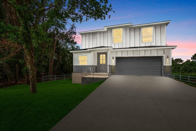 147 Kahana Ln, Bastrop, TX 78602 - view of front of house featuring board and batten siding, a garage, and concrete driveway