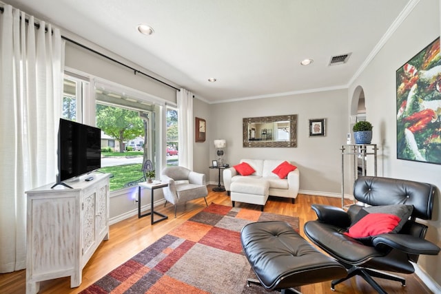 1807 Cullen Ave, Austin, TX 78757 - living area with ornamental molding, recessed lighting, light wood finished floors, and arched walkways