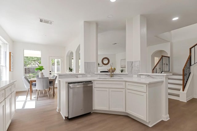 811 Zappa Dr, Cedar Park, TX 78613 - kitchen with stainless steel dishwasher, light wood-type flooring, white cabinetry, light stone counters, and recessed lighting