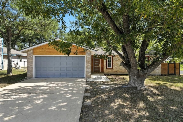 2400 Burly Oak Dr, Austin, TX 78745 - view of front facade with a garage, brick siding, and concrete driveway