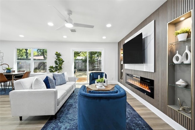 2400 Burly Oak Dr, Austin, TX 78745 - living area featuring wood finished floors, ceiling fan, recessed lighting, and a fireplace