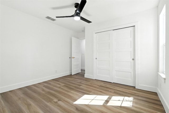 2400 Burly Oak Dr, Austin, TX 78745 - unfurnished bedroom featuring wood finished floors, a closet, and ceiling fan