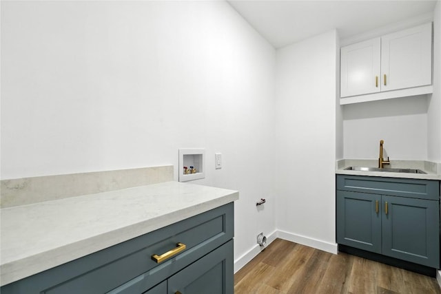 2400 Burly Oak Dr, Austin, TX 78745 - laundry room with hookup for a washing machine, dark wood finished floors, and cabinet space