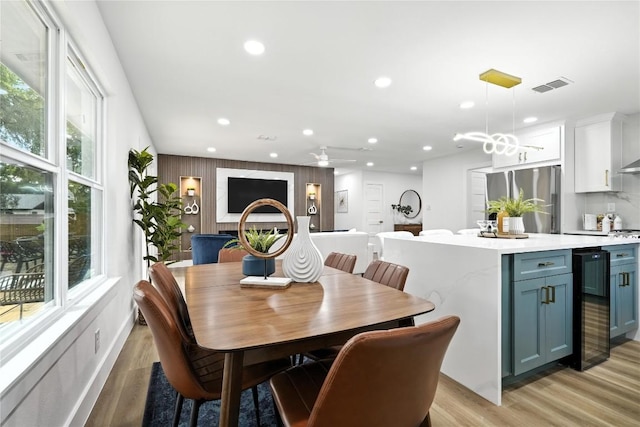2400 Burly Oak Dr, Austin, TX 78745 - dining room featuring beverage cooler, light wood finished floors, and recessed lighting