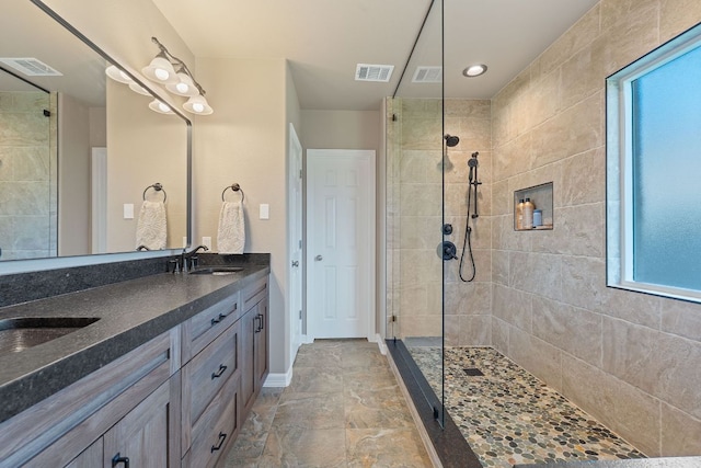 2634 Plantation Dr, Round Rock, TX 78681 - full bath with walk in shower, double vanity, and stone finish flooring