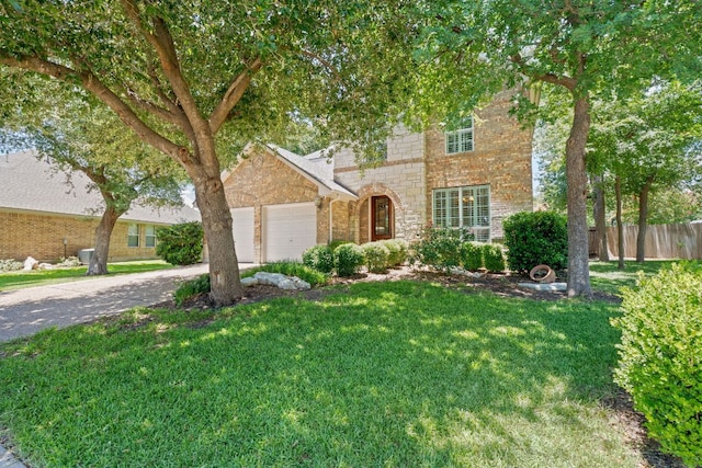 2634 Plantation Dr, Round Rock, TX 78681 - view of front of home with an attached garage, driveway, stone siding, and brick siding