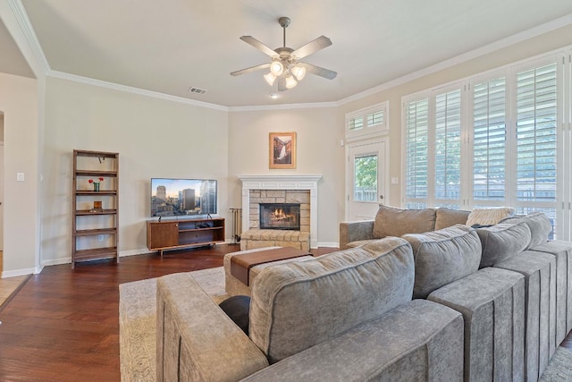 2634 Plantation Dr, Round Rock, TX 78681 - living area with a ceiling fan, dark wood-style flooring, a fireplace, and crown molding