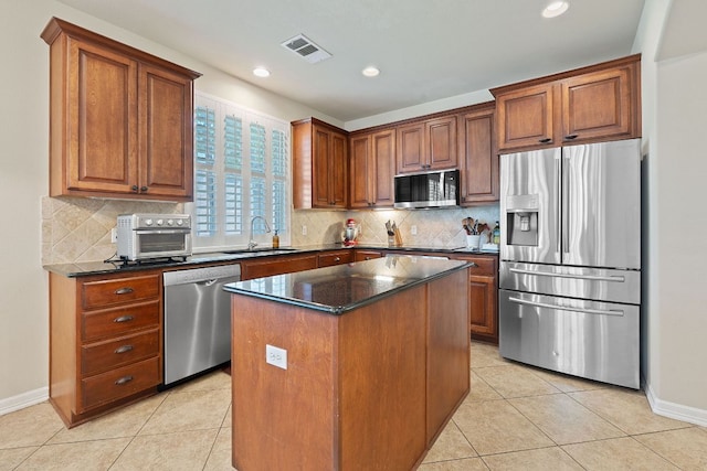 2634 Plantation Dr, Round Rock, TX 78681 - kitchen with stainless steel appliances, light tile patterned floors, a center island, backsplash, and recessed lighting
