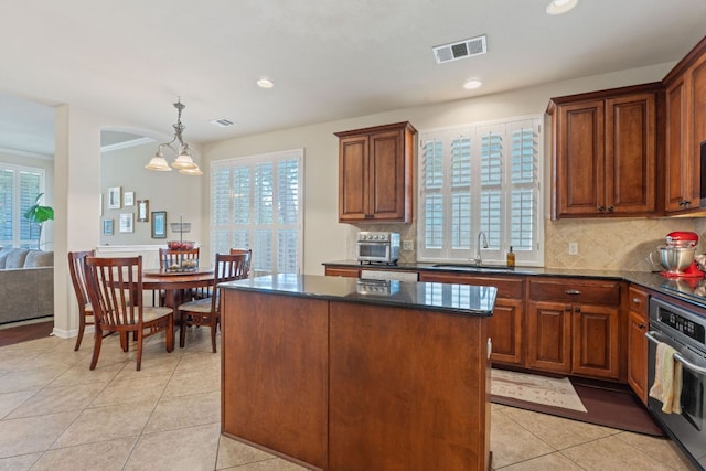 2634 Plantation Dr, Round Rock, TX 78681 - kitchen with stainless steel oven, healthy amount of natural light, light tile patterned floors, decorative backsplash, and recessed lighting