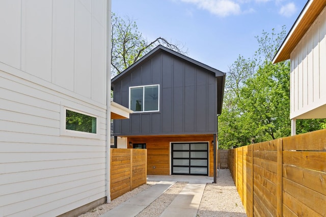 2813 Prado Unit 2, Austin, TX 78702 - view of front of home with board and batten siding, concrete driveway, and a garage