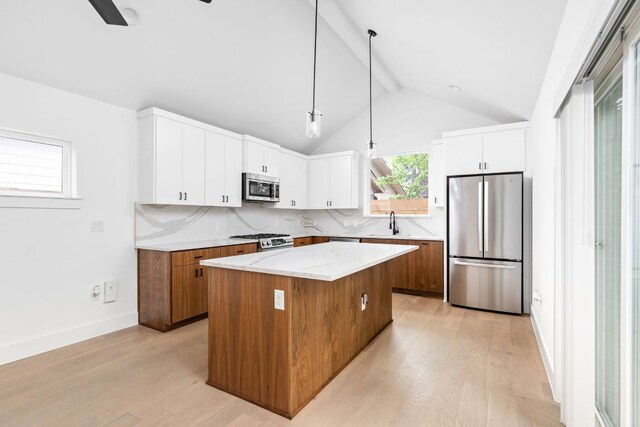 2813 Prado Unit 2, Austin, TX 78702 - kitchen with stainless steel appliances, a center island, light wood-type flooring, and white cabinets