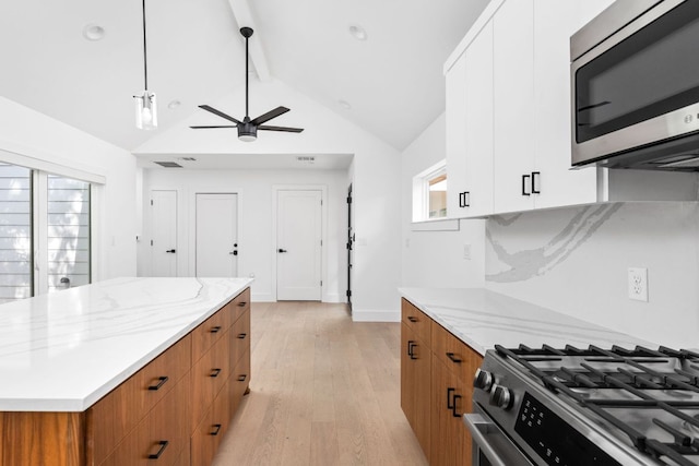 2813 Prado Unit 2, Austin, TX 78702 - kitchen featuring appliances with stainless steel finishes, brown cabinets, ceiling fan, and light wood-type flooring